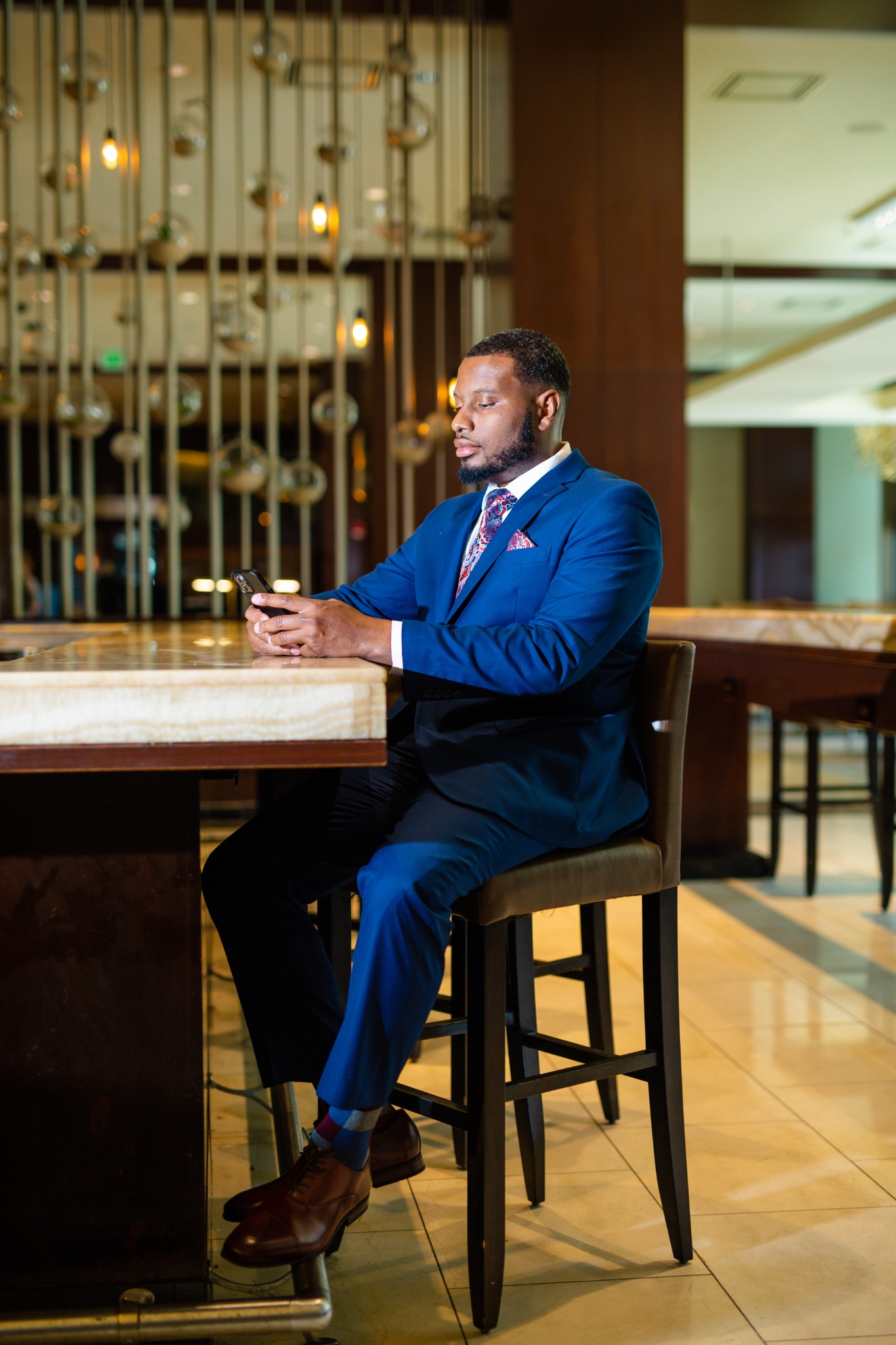 Antoine Sherman seated at a table in a blue suit